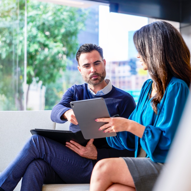 Two people looking at a server walking down steps.