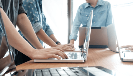Two people looking at a server rack.