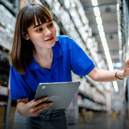 Woman holding a tablet while checking inventory