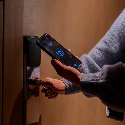 Person using their phone to unlock their hotel room door